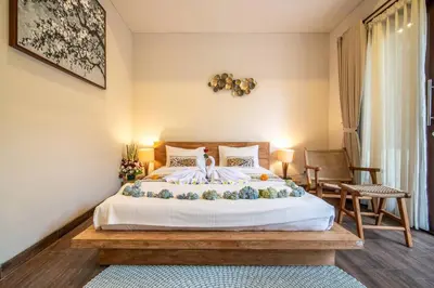 a bedroom with a large bed with flowers on it at Arts Cherry Villa Satu Two-Bedroom with Private Pool Kuta in Kerobokan