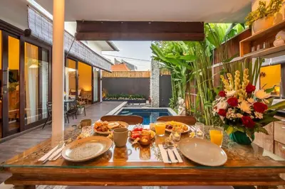 a wooden table with food on top of it at Arts Cherry Villa Dua Two-Bedroom with Private Pool Kuta in Kerobokan
