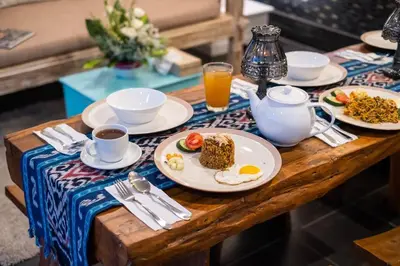 a table with plates of breakfast food on it at Bens Seminyak Villa Two-Bedroom with Private SwimmingPool in Seminyak