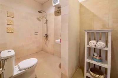 a bathroom with a white toilet and a shower at Bens Bidadari Villa Two-Bedroom with Private Pool Kuta in Seminyak