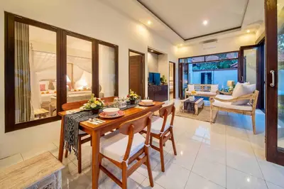 a dining room with a wooden table and chairs at Bens Bidadari Villa Two-Bedroom with Private Pool Kuta in Seminyak