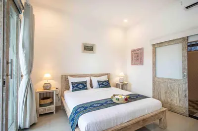 a bedroom with a bed with a stuffed animal on it at Bens Kenanga Villa Three-Bedroom with Private Pool Kuta in Kerobokan