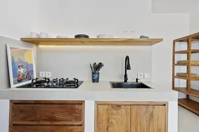 a kitchen with a sink and a stove at White Residence - Art & Boutique Villas in Seminyak