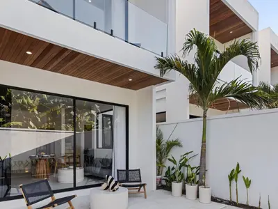 a house with a palm tree on the side of it at White Residence - Art & Boutique Villas in Seminyak