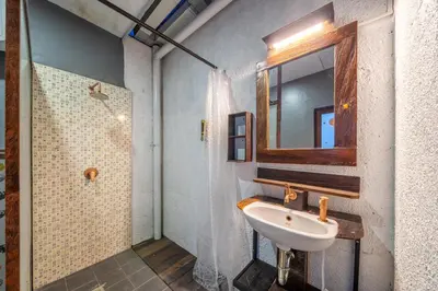 a bathroom with a sink and a mirror at Senyum Bali Inn 1BR Sanur in Sanur