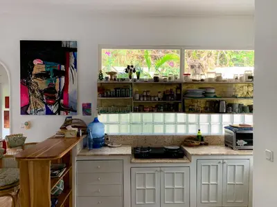 a kitchen with white cabinets and a window at Tropical Oasis 2 BR Villa - Near Beach in Seminyak