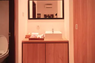 a bathroom with a sink and a toilet at Amaya Residence Jimbaran in Jimbaran
