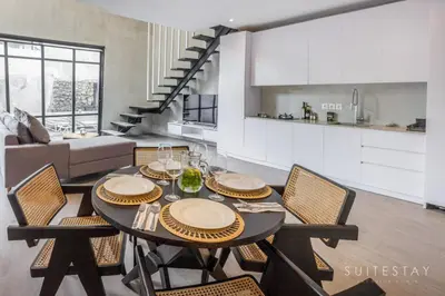 a dining room table and chairs in a living room at Modern Duplex With Stylish Design in Canggu