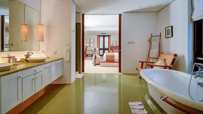 a bathroom with a tub and a sink at Casa Evaliza by Elite Havens in Seminyak