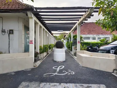 a parking lot with a plant in a planter in front of a building at Privat Pool Villa at Kuta in Kuta