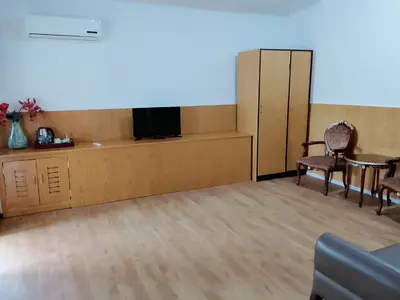 a waiting room with two chairs and a tv and a table at Privat Pool Villa at Kuta in Kuta