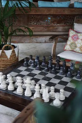 a chessboard on a table in a living room at Palm Merah Villa in Umalas