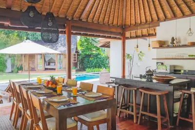 a kitchen and dining room with a table and chairs at Villa Charlie Seminyak in Badung