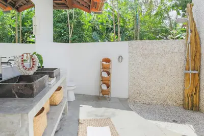 a bathroom with a sink and a shower at Villa Charlie Seminyak in Badung