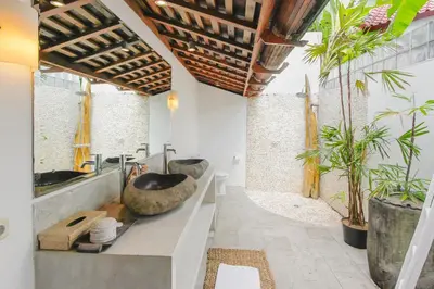 a bathroom with two sinks and some plants at Villa Charlie Seminyak in Badung