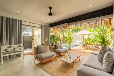 a living room with a couch and chairs and a table at Lovely 1 BR villa walking distance to the beach in Seminyak