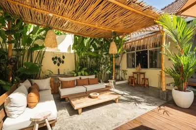 an outdoor patio with a couch and a table at Lovely 1 BR villa walking distance to the beach in Seminyak