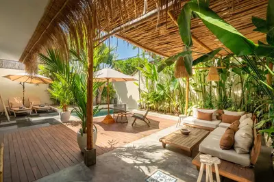 a living room with a couch and some plants at Lovely 1 BR villa walking distance to the beach in Seminyak