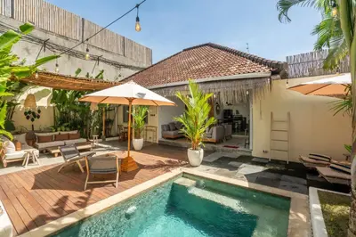a backyard with a swimming pool and a house at Lovely 1 BR villa walking distance to the beach in Seminyak