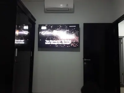 a television on a wall in a room at Chandra's House in Pesanggaran
