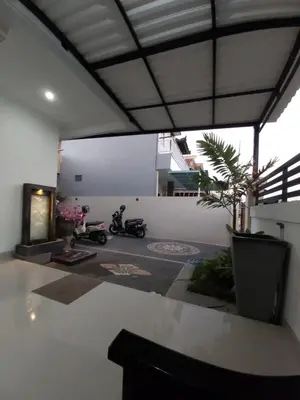 a room with two motorcycles parked in it at Chandra's House in Pesanggaran