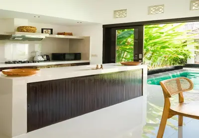 an island in a kitchen with a swimming pool at Gemstones Villa in Seminyak