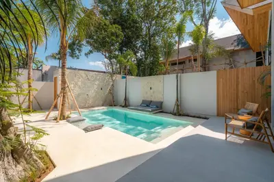 a swimming pool in the backyard of a house at Vaya - Luxe & Stylish 3BR Villa Just Steps from the Beach in Seminyak
