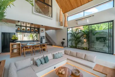 an open living room with a large couch and a table at Vaya - Luxe & Stylish 3BR Villa Just Steps from the Beach in Seminyak