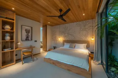 a bedroom with a bed and a ceiling fan at Vaya - Luxe & Stylish 3BR Villa Just Steps from the Beach in Seminyak