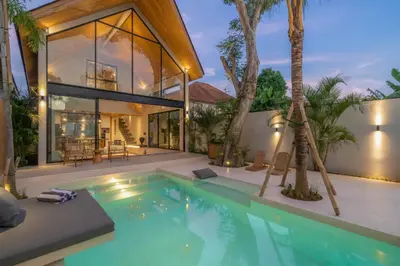 a villa with a swimming pool and a house at Vaya - Luxe & Stylish 3BR Villa Just Steps from the Beach in Seminyak