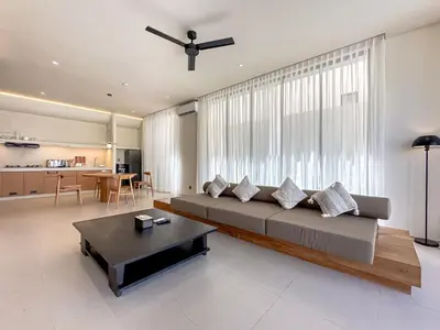 a living room with a large couch and a table at Saint Cloud Villa Umalas in Canggu