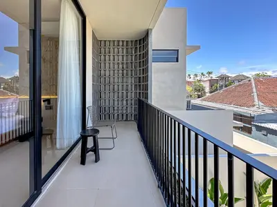 a balcony of a house with a chair on it at Saint Cloud Villa Umalas in Canggu