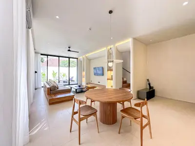 a living room with a table and chairs and a couch at Saint Cloud Villa Umalas in Canggu