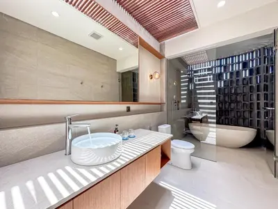 a bathroom with a sink and a toilet and a tub at Saint Cloud Villa Umalas in Canggu