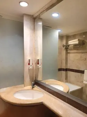 a bathroom with two sinks and a large mirror at C&C Apartment Jayakarta Residence Legian Bali A 6319 in Seminyak