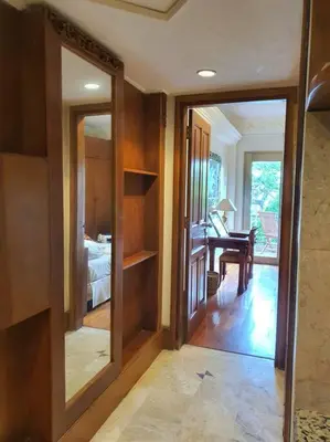 a hallway with mirrors and a room with a desk at C&C Apartment Jayakarta Residence Legian Bali A 6319 in Seminyak