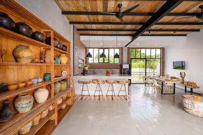 a large room with wooden shelves with pots and vases at Villa Anzo by DreamAwayBali in Seminyak