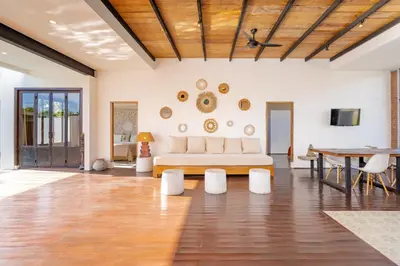 a living room with a couch and a table at Villa Anzo by DreamAwayBali in Seminyak