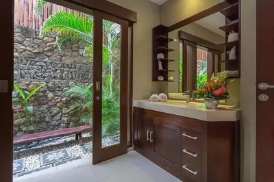 a bathroom with a sink and a mirror at Villa Green Mango 2 Seminyak Bali in Seminyak