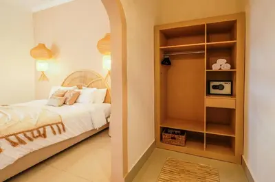 a bedroom with a bed and a microwave in it at Casa De Beji Seminyak in Seminyak