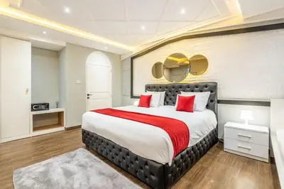 a bedroom with a large bed with red pillows at Luxury Villa Belvedere Bali in Seminyak in Seminyak