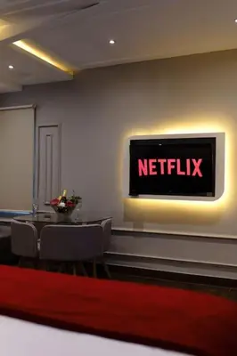 a netflix sign on a wall with a table and chairs at Luxury Villa Belvedere Bali in Seminyak in Seminyak
