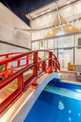 a house with a swimming pool and a red railing at Luxury Villa Belvedere Bali in Seminyak in Seminyak