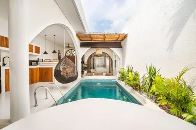 a kitchen and a swimming pool in a house at La Feliz Villa Seminyak in Seminyak
