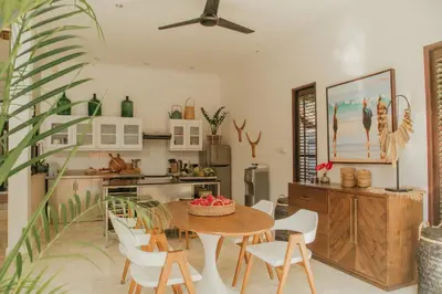 a kitchen and dining room with a table and chairs at Villa Eight in Seminyak