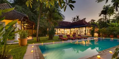 a house with a swimming pool in front of a house at Villa Eight in Seminyak
