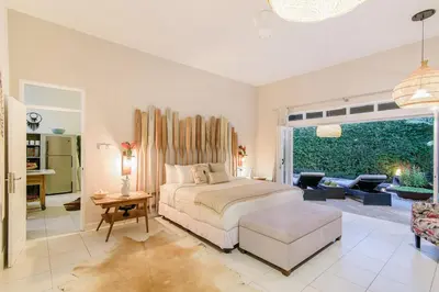 a bedroom with a bed and a living room at Villa Bloom 3 - Coastal Beach Villa 2 brm Sleeps 4 SEMINYAK BEACH in Seminyak