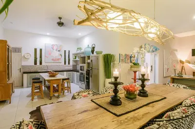 a kitchen and dining room with a wooden table at Villa Bloom 3 - Coastal Beach Villa 2 brm Sleeps 4 SEMINYAK BEACH in Seminyak