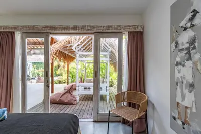 a bedroom with a bed and a sliding glass door at Villa Sukacita - Family Friendly 4BR Seminyak Eat Street 900m Walk To Beach in Seminyak