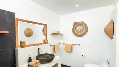 a bathroom with a sink and a mirror on the wall at Villa Sukacita - Family Friendly 4BR Seminyak Eat Street 900m Walk To Beach in Seminyak